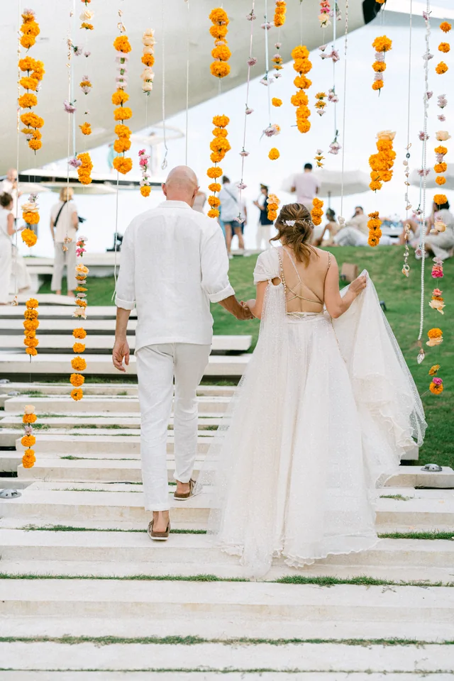 Guests walking the marigold aisle