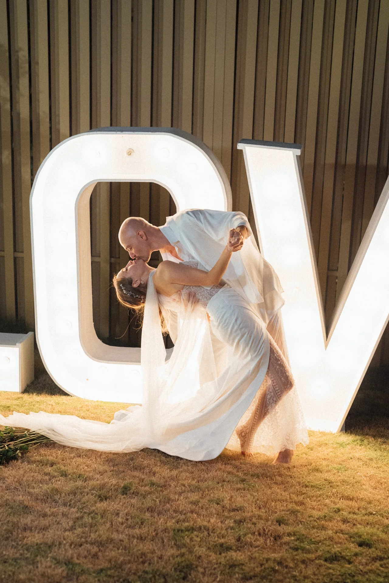 Guests in front of giant light-up birthday letters