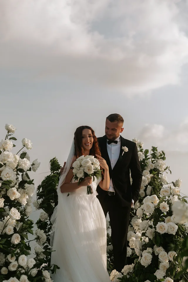 The couple at the floral arch