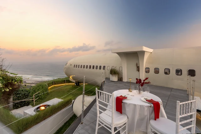 Dinner set beside the jet, fire pit lit