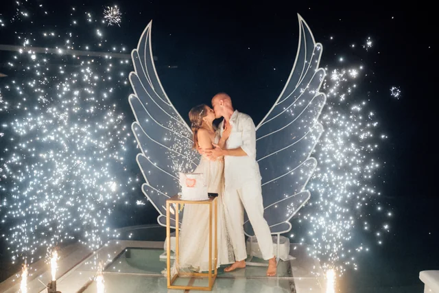 Sparklers behind the couple at the cake