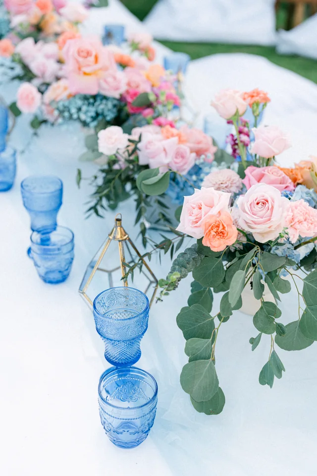 Florals and glassware on a set table